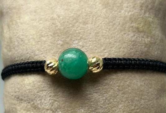 PULSERA TEJIDA A MANO ESFERA EN ORO 18KTE Y ESFERA ESMERALDA