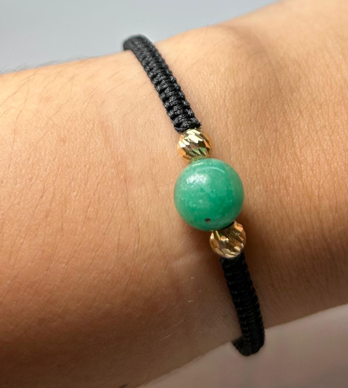 PULSERA TEJIDA A MANO ESFERA EN ORO 18KTE Y ESFERA ESMERALDA