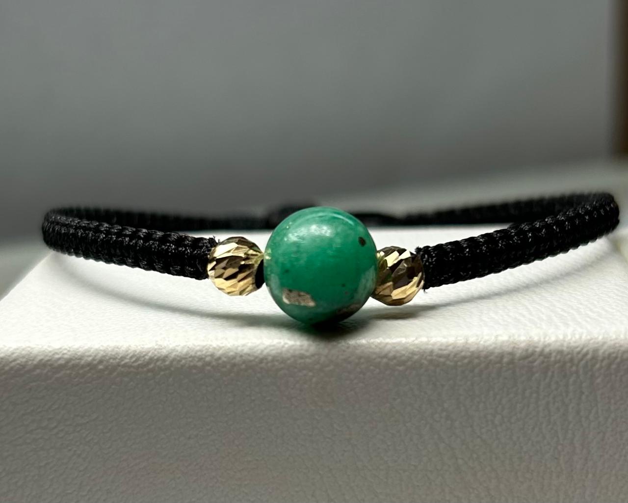PULSERA TEJIDA A MANO ESFERA EN ORO 18KTE Y ESFERA ESMERALDA